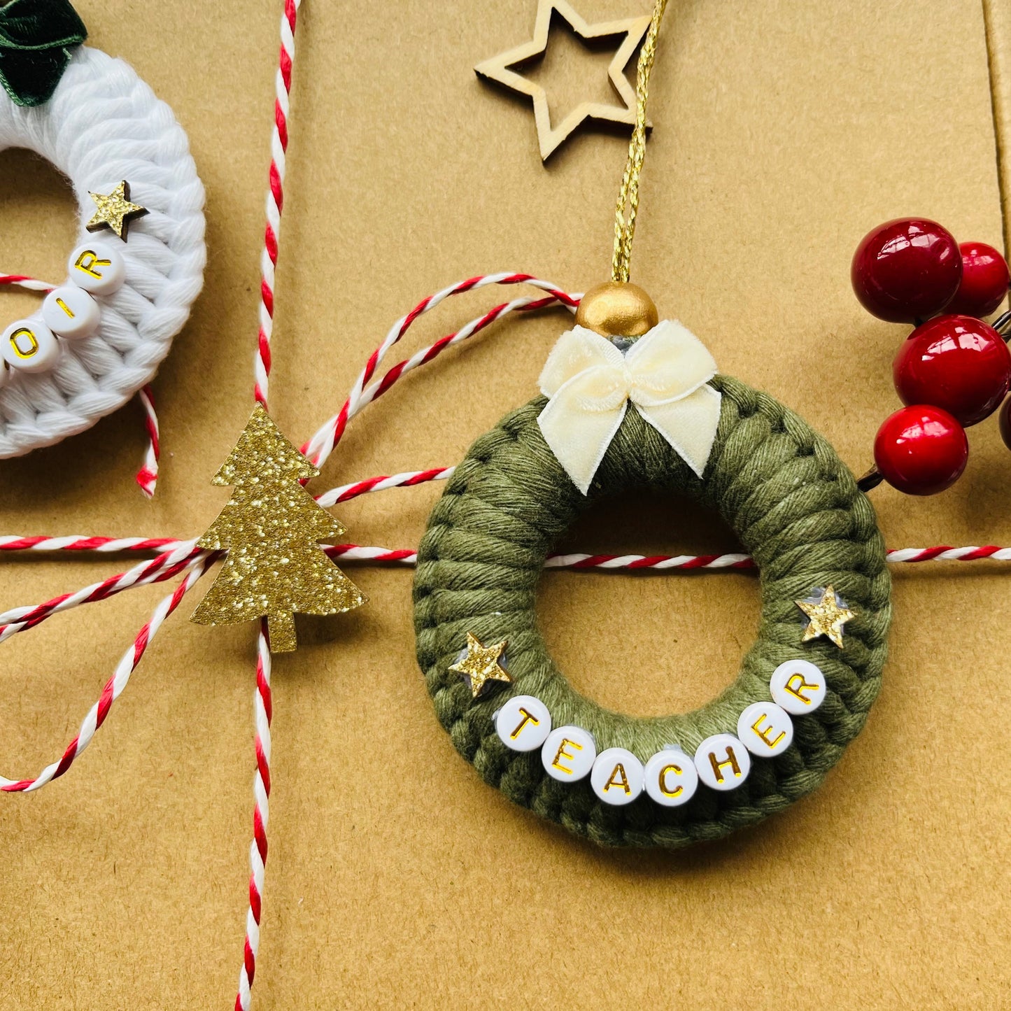 Decorative Christmas wreaths with string and berries on a textured surface