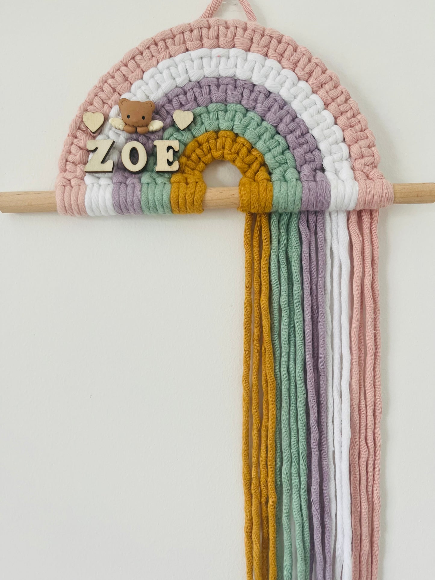 Personalised colourful macramé rainbow on a wooden dowel