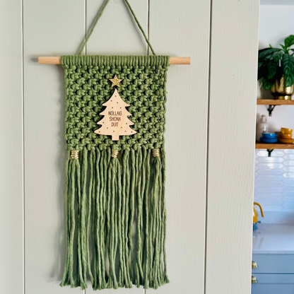 Macrame Christmas wall hanging in green with a wooden tree and gold accents