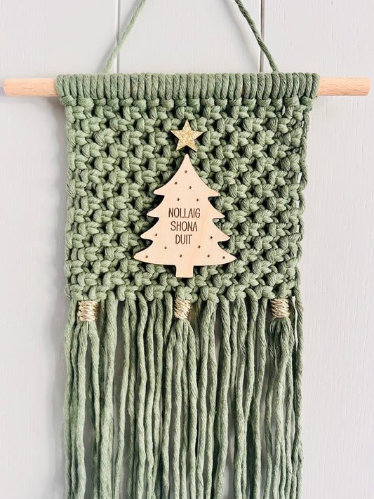 Macrame Christmas wall hanging in green with a wooden tree and gold accents